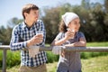 Country couple of farmers drink milk in field near fenc Royalty Free Stock Photo