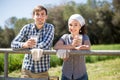 Country couple of farmers drink milk in field near fenc Royalty Free Stock Photo