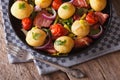 Country Food: Young potatoes with onions and bacon top view Royalty Free Stock Photo