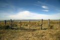 Country gate. Landscape of field and mountains. Nature. Blue sky with clouds. Grasslands Green. Outdoor. Access door. Chains. Moun