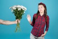 A country girl in a red plaid shirt carefully refuses flowers Royalty Free Stock Photo