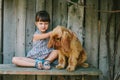 Country girl sitting on a bench with her dog under vine. wooden Royalty Free Stock Photo