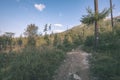 country gravel road leading up to the mountains - vintage retro Royalty Free Stock Photo