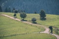 country gravel road leading up to the mountains - vintage retro Royalty Free Stock Photo