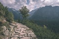 country gravel road leading up to the mountains - vintage retro Royalty Free Stock Photo