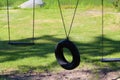 Two Wooden Board Swings Flank a Tire  Swing Royalty Free Stock Photo