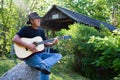 Country Guitar player at covered bridge Royalty Free Stock Photo