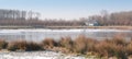 Country house on the edge of a lake with a thin layer of ice