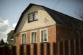 A country house near the village. The cottage behind the fence Royalty Free Stock Photo