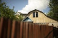 A country house near the village. The cottage behind the fence Royalty Free Stock Photo