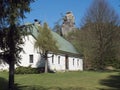 Country house, old rustic cottage with sandstone rock pillar in spring landscape at Lusatian Mountains with spring green