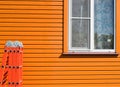 A country house after painting. Folding staircase on the background of a freshly painted wooden house