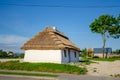 Country house under a thatched roof in the old style. Summer rural landscape. Vintage design Royalty Free Stock Photo