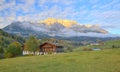 Country houses at foothills of a rocky mountain range lighted up by golden sunlight at sunset Royalty Free Stock Photo