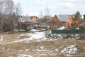 Country houses on a hillside, snow almost melted, paths, april 2021 Royalty Free Stock Photo