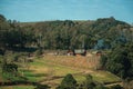 Country houses on top of hill with green fields Royalty Free Stock Photo