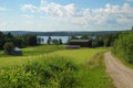 Country landscape with earth road and lake Royalty Free Stock Photo