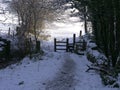Country lane and stile in England covered in snow