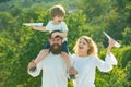 Country life. Adopt kid. Dad mom and his child son are playing on sky background. Spring time. Happy father giving Royalty Free Stock Photo