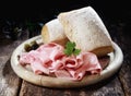 Country lunch with cured ham and crusty rolls Royalty Free Stock Photo