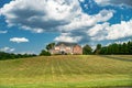 Country luxury brick house with large lawn under blue clouds Royalty Free Stock Photo