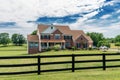 Country modern mansion in traditional American style. large green lawn and trees