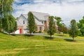 Country modern mansion in traditional American style. large green lawn and trees