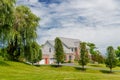 Country modern mansion in traditional American style. large green lawn and trees