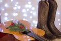 Country music christmas with acoustic guitar and cowboy shoes Royalty Free Stock Photo