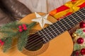 Country music christmas background with guitar and cowboy boots Royalty Free Stock Photo