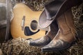 Country music festival live concert or rodeo with cowboy hat guitar and boots in barn Royalty Free Stock Photo
