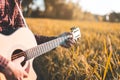 Country music, Man playing acoustic guitar in rice field Royalty Free Stock Photo