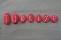 TÃÂ¼rkiye, souvenir with red colored stones over beach sand Royalty Free Stock Photo