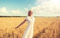 Smiling young woman in white dress on cereal field Royalty Free Stock Photo