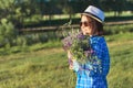 Country portrait of an adult beautiful woman in hat with bouquet of wildflowers Royalty Free Stock Photo