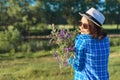 Country portrait of an adult beautiful woman in hat with bouquet of wildflowers Royalty Free Stock Photo