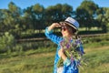 Country portrait of an adult beautiful woman in hat with bouquet of wildflowers Royalty Free Stock Photo