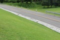 Country road along hillside green grass. Royalty Free Stock Photo