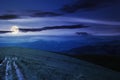 country road through alpine meadow at night Royalty Free Stock Photo