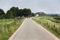 Country road with bikers in the distance Royalty Free Stock Photo