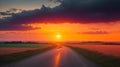 A country road disappearing into the horizon under a sky ablaze with sunset colors