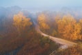 Country road in the early autumn misty morning