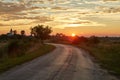 Country road through in glowing sunset