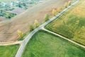 Country road intersection with dirt roads between agricultural fields. autumn landscape. drone photo Royalty Free Stock Photo