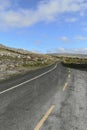 Country road intersects The Burren limestone karst landscape