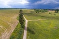 Country road in the July landscape before a thunderstorm