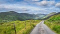 Country road leading to majestic Black Valley with lake and mountain range Royalty Free Stock Photo