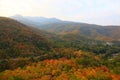 Country road through the mountain and small village which has colorful autumnal fall scenery forest, rural Chiang Mai, Thailand Royalty Free Stock Photo