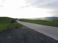 Country road over rolling green hills and valleys in winter . Tuscany, Italy