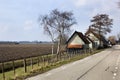 Country road and a plowed field in Dutch polder landscape